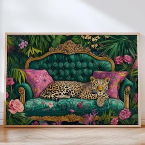 May include: A leopard lounges on a luxurious green velvet sofa with gold accents. The sofa is surrounded by lush tropical foliage and pink flowers.