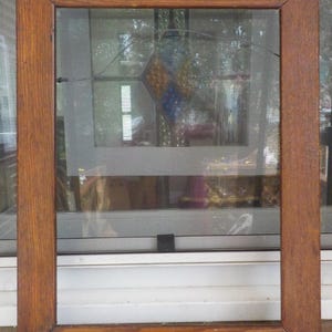 May include: A rectangular wooden picture frame with a medium brown finish and a visible wood grain texture. The frame features mitered corners and a simple, flat profile, providing a sturdy border for display purposes without any glass or backing.