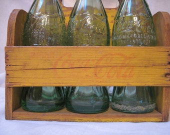 1940's wooden Coca Cola holder and 6 vintage bottles