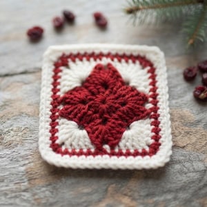 May include: A square crochet coaster featuring a central dark red star motif surrounded by cream-colored yarn. The border consists of alternating rows of dark red and cream stitches, creating a geometric pattern with a textured, hand-crafted appearance.