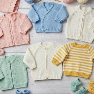 May include: A collection of knitted baby garments including six cardigans in pastel pink, light blue, cream, and mint green, one yellow and white striped sweater, and several pairs of matching knitted booties, arranged with a measuring tape.