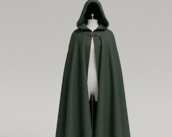 May include: A dark green hooded cloak with a brown leather clasp. The cloak is displayed on a mannequin against a neutral background. The cloak has a long, flowing design.