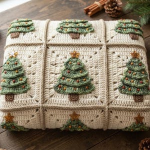 May include: A square crochet blanket featuring a grid of cream-colored squares, each adorned with a three-dimensional green Christmas tree applique. Each tree has a brown trunk, small colorful bead ornaments, and a gold star topper.