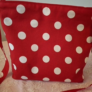 Be theme park ready with this cute Red Dot shoulder purse with open pockets on one side for a cell phone & a lipstick pocket on the inside