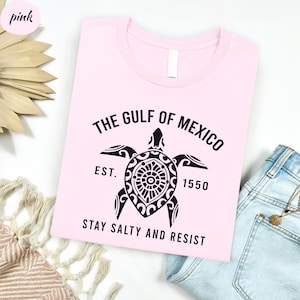 a pink shirt with a turtle on it