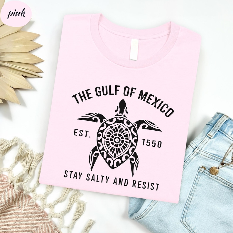 a pink shirt with a turtle on it
