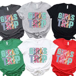 a collection of six t-shirts, each with a unique design and color, featuring the text "Girls Trip" prominently.