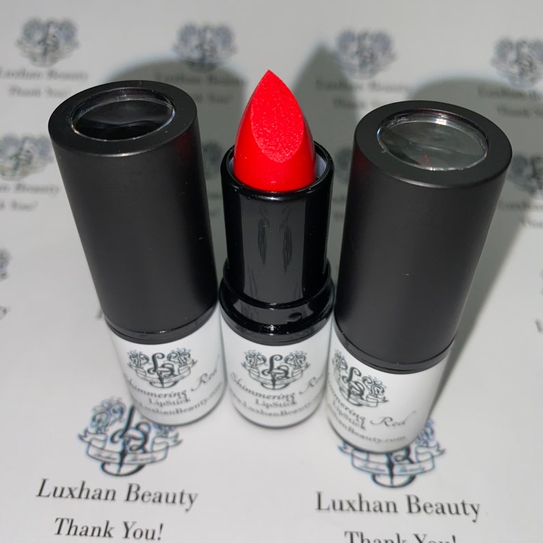 May include: Three red lipstick tubes with black caps and white labels that say "Luxhan Beauty" and "Shimmering Lipstick".