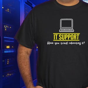 May include: Black t-shirt with a white laptop icon and the text "IT SUPPORT Have you tried rebooting it?"