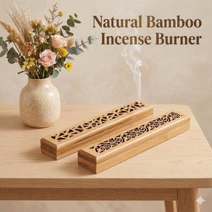 Peut inclure: Deux brûleurs d'encens en bambou naturel avec des motifs découpés complexes sont présentés sur une table en bois clair. Le texte "Natural Bamboo Incense Burner" est visible. Un vase de fleurs est en arrière-plan, et de la fumée d'encens s'élève d'un brûleur.