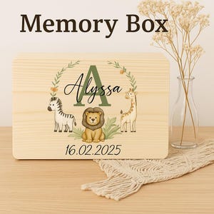 May include: A wooden memory box with the text "Memory Box" at the top. The box features a decorative design with the name "Alyssa", a zebra, a lion, and a giraffe. The date "16.02.2025" is also displayed.