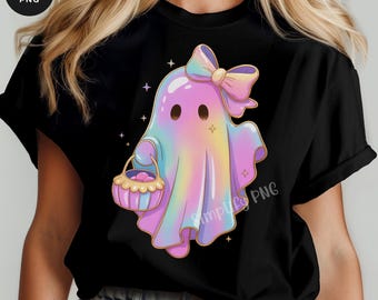 Puede incluir: Camiseta negra con un fantasma de dibujos animados en colores pastel rosa, azul y amarillo, con un lazo y una cesta. La camiseta tiene el texto "INSTANT DOWNLOAD" en la parte inferior. Lindo tema de Halloween.