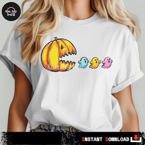 May include: White t-shirt with a Halloween design. It features a yellow and orange pumpkin with a jagged mouth, and three ghosts in blue, yellow, and pink. The words "INSTANT DOWNLOAD" are at the bottom of the image.