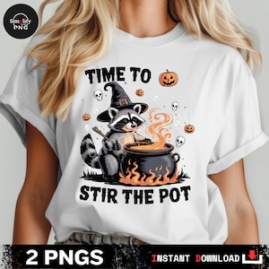 May include: White t-shirt with a Halloween-themed graphic. The design features a raccoon wearing a witch hat, stirring a cauldron with the text "TIME TO STIR THE POT". Includes pumpkins and skulls.