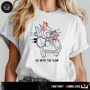 May include: White t-shirt featuring a black and white anatomical heart illustration with red and blue accents. The text "GO WITH THE FLOW" is printed below the graphic. A medical or science-themed design.