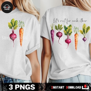 May include: Light gray t-shirt featuring a watercolor illustration of a beet and carrot on the front. The back of the shirt displays a watercolor design of various root vegetables with the text "Let's root for each other."