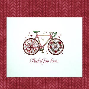 May include: A pink bicycle illustration with a green seat and handlebars, adorned with hearts and flowers. The wheels are decorated with arrows and a heart-shaped floral design. The text "Pedal for love" is written below the bicycle.