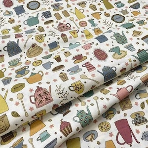 May include: Cream-coloured fabric featuring a repeating pattern of teacups, teapots, spoons, and cakes in various colours. The design includes text such as "Billy Tea" and "Tea Time". Ideal for quilting and craft projects.