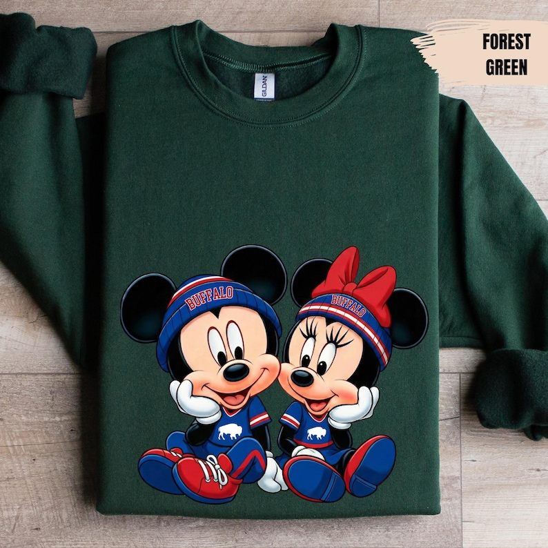 A green sweatshirt with a graphic of two cartoon mice wearing sports gear and the word " buffalo" on their hats.