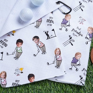 May include: White golf towel with a repeating pattern of cartoon golfers and golf clubs. The towel has the phrases "Best Friend By Par" and "Best Grandpa By Par" printed on it. Includes golf balls and a tee holder.
