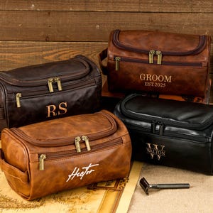 May include: A handmade wooden sign with the text "Welcome" in a playful font. The sign features a distressed white background and a dark stained wooden frame. A small, decorative heart is attached to the bottom.