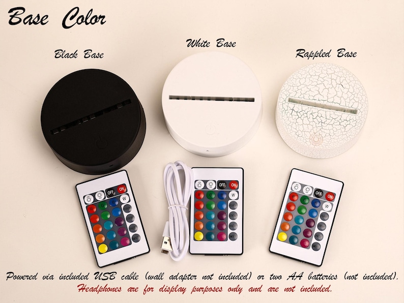 May include: A product display featuring three circular bases in black, white, and a cracked white finish. Each base has a slot for a light. Three remote controls with multi-colored buttons and a USB cable are also shown. The text "Base Color" is at the top.