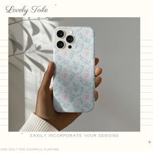 Pode incluir: Capa de telem&oacute;vel azul claro com um padr&atilde;o floral e de cora&ccedil;&atilde;o, segurada por uma m&atilde;o. A capa tem um design repetido de cora&ccedil;&otilde;es cor-de-rosa e elementos florais. O texto "Lovely Toile" est&aacute; no topo e "EASILY INCORPORATE YOUR DESIGNS" na parte inferior.