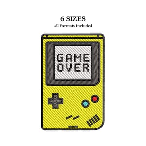 May include: Embroidered design of a yellow retro handheld game console with the words "GAME OVER" on the screen. The design includes a directional pad, buttons, and a speaker. The text "6 SIZES All Formats Included" is at the top.