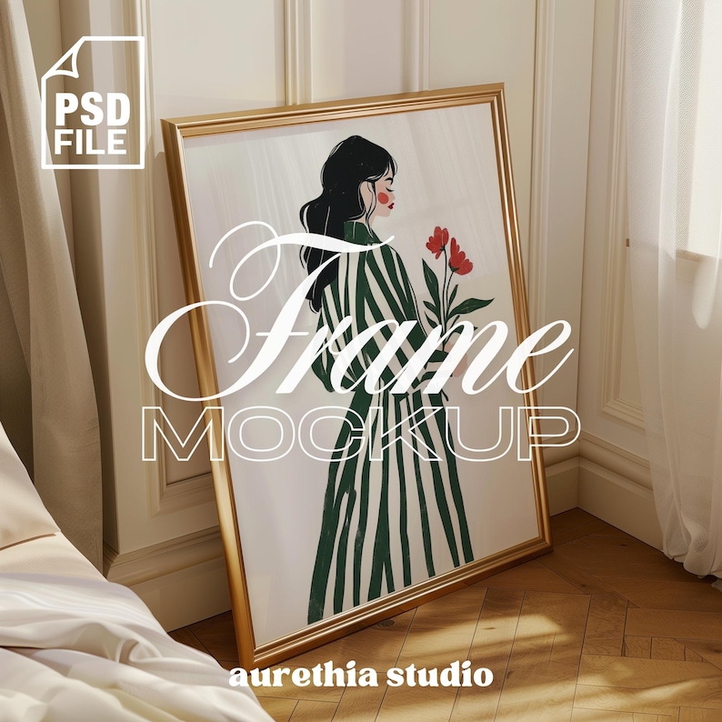 May include: A gold frame mockup with a white background and a colorful illustration of a woman in a striped dress holding red flowers. The text "Frame Mockup" is written in a stylized font below the image. The text "aurethia studio" is written in a smaller font below the image.