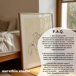 May include: A framed print featuring a minimalist line drawing of a person in motion. The artwork is set against a cream-colored background and is enclosed in a light-colored wooden frame. Text on the image includes "F.A.Q." and "aurethia studio".