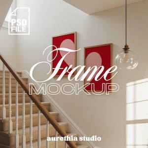 Puede incluir: Maqueta de dos obras de arte enmarcadas con fondos rojos y formas de corazón rosas, colgadas en una pared blanca. Las palabras "Frame MOCKUP" están superpuestas en escritura blanca. También se ve una escalera con barandillas de madera y una lámpara colgante de cristal transparente.