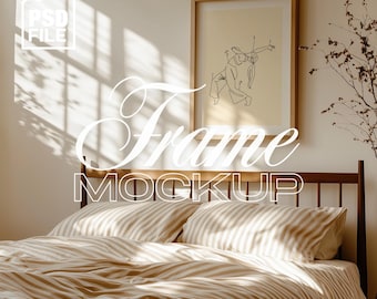 May include: A bedroom scene featuring a framed artwork above a bed with striped bedding. The artwork has a simple line drawing. The words "Frame Mockup" are displayed in a decorative font. The image has a warm, neutral color palette.