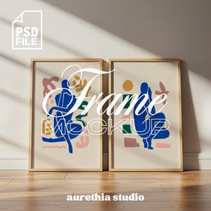 Puede incluir: Dos impresiones artísticas enmarcadas con figuras abstractas en azul, rosa y verde sobre un fondo crema. Los marcos son de madera clara. Las palabras "Frame Mockup" están superpuestas a las impresiones. El texto "aurethia studio" está en la parte inferior.