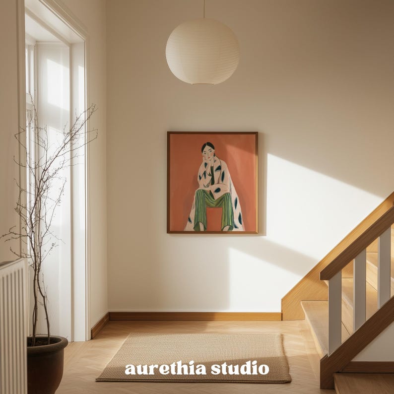 May include: An interior hallway with a painting and a rug. The painting features a person in green pants and a patterned coat. A paper lantern hangs from the ceiling. The rug has the text "aurethia studio".