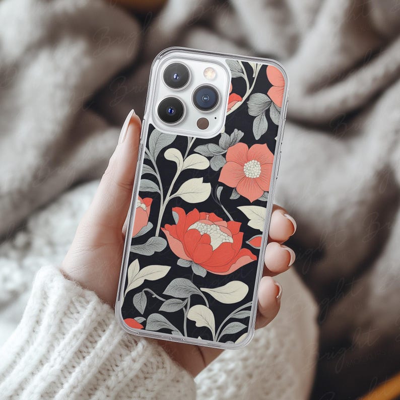 Phone case mockup of a clear phone case held by a girl's hand that's wearing a wool white sweater, in front of a cozy blanket. Works in Photoshop, Photopea and Canva.