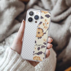 Phone case mockup of a clear phone case held by a girl's hand that's wearing a wool white sweater, in front of a cozy blanket. Works in Photoshop, Photopea and Canva.