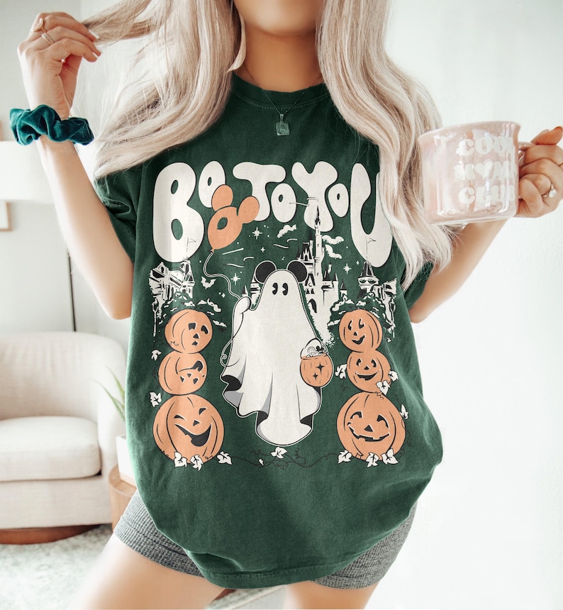 May include: Dark green t-shirt with a Halloween graphic. The design includes a ghost with Mickey Mouse ears, pumpkins, and the text "Boo to You". The shirt is a casual, comfortable style.
