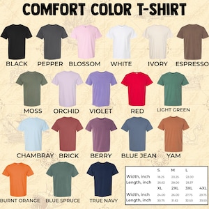 Pu&ograve; includere: Esposizione di magliette Comfort Color in vari colori, tra cui nero, bianco e rosso. L'immagine include una tabella delle taglie con misure in pollici, che corrispondono a 46,36 cm, 51,44 cm, 55,88 cm, 60,96 cm, 66,04 cm, 70,49 cm e 75,57 cm.