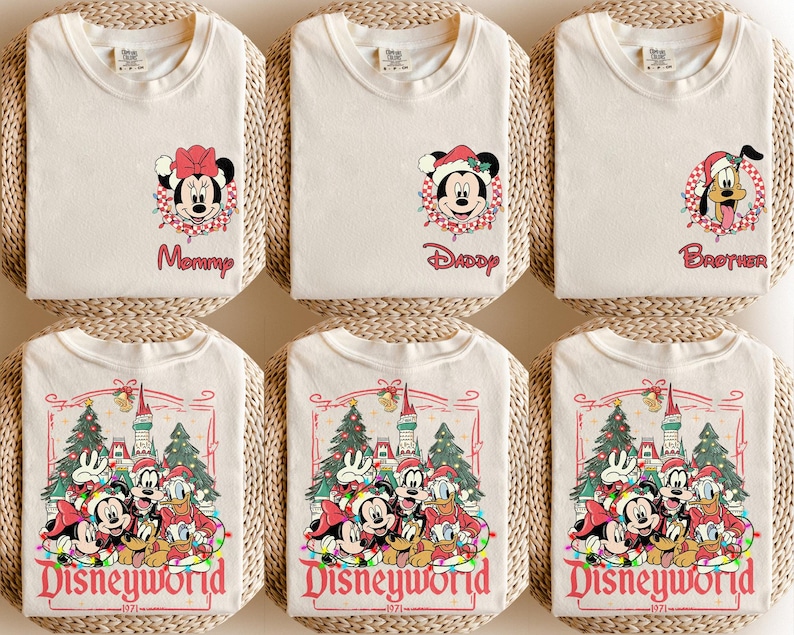 May include: Off-white t-shirts with Disney character graphics. One shirt features Minnie Mouse with the word "Mommy", another has Mickey Mouse with "Daddy", and a third has Pluto with "Brother". Other shirts display a Disneyworld graphic.