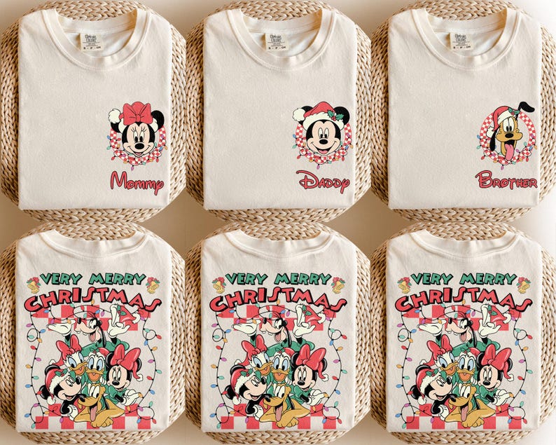 May include: Off-white t-shirts with Christmas-themed cartoon graphics. Designs include Minnie Mouse, Mickey Mouse, and Pluto in Santa hats, and the text "Mommy", "Daddy", and "Brother". Other shirts say "Very Merry Christmas".