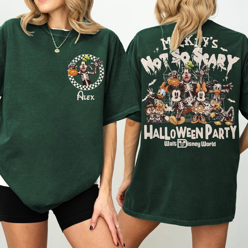 May include: Dark green t-shirt featuring a Halloween-themed design. The front displays a skeleton character within a checkered circle, with the name "Alex" below. The back showcases a group of cartoon characters with the text "Mickey's Not So Scary Halloween Party" and "Walt Disney World".