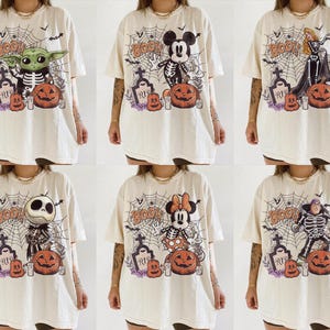 May include: A collection of six off-white t-shirts featuring various cartoon characters dressed in skeleton costumes. Each shirt displays a spiderweb background, a tombstone labelled RIP, a carved pumpkin, and the word BOO in orange lettering.