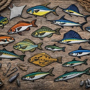 May include: A collection of embroidered fish patches in various colors, including blue, yellow, orange, and green, arranged on a wooden surface. The patches depict different species of fish, with detailed stitching. Fishing-related accessories are also present.
