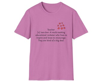 May include: A pink t-shirt with a definition of the word "teacher" printed on it. The definition reads: "(n) tee-cher: A multi-tasking educational rockstar who lives to inspire and loves to encourage. They are kind of a big deal."