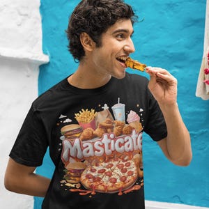 May include: A black t-shirt featuring a graphic print of various fast food items, such as pizza, burgers, chips, chicken, and a milkshake. The text "Masticate" is printed in a bold, colourful font.