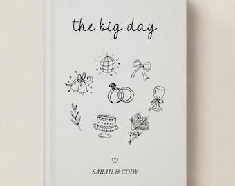 May include: A white hardcover book with the text the big day in black script at the top. The cover features black line drawings of a disco ball, bow, wedding rings, champagne glass, cake, bouquet, and leaves. The names SARAH & CODY appear below.
