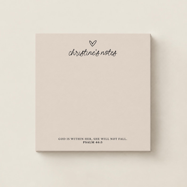 May include: A square notepad with a light beige background. The top features a small hand-drawn heart icon above the text christine's notes in a cursive font. The bottom includes the text GOD IS WITHIN HER, SHE WILL NOT FALL. PSALM 46:5.