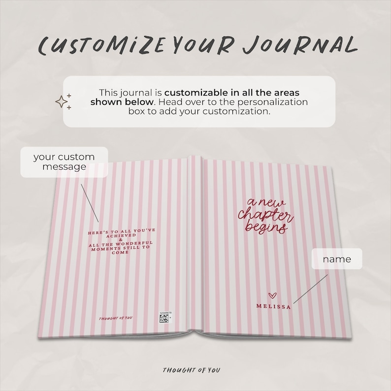 May include: Open journal with pink and white striped pages. Text on the left page reads "Here's to all you've achieved & all the wonderful moments still to come." The right page says "a new chapter begins." The journal is customizable.