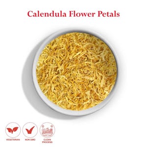 May include: A white bowl filled with dried calendula flower petals. The petals are a bright yellow color and have a slightly shredded texture. The bowl is sitting on a white background. The text "Calendula Flower Petals" is written in red above the bowl.
