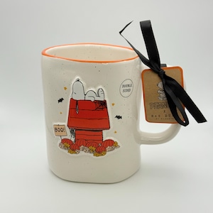Snoopy Halloween mug by Rae Dunn | Peanuts spooky season mug with Snoopy graphic resting on his iconic doghouse in fall colors | Great gift